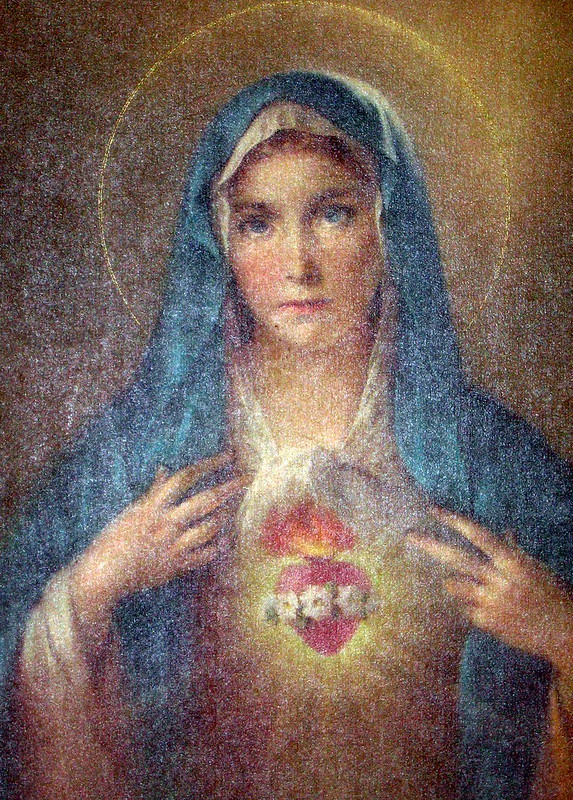 Religious artwork of the Virgin Mary with Sacred Heart symbol displayed on chest against soft textured background